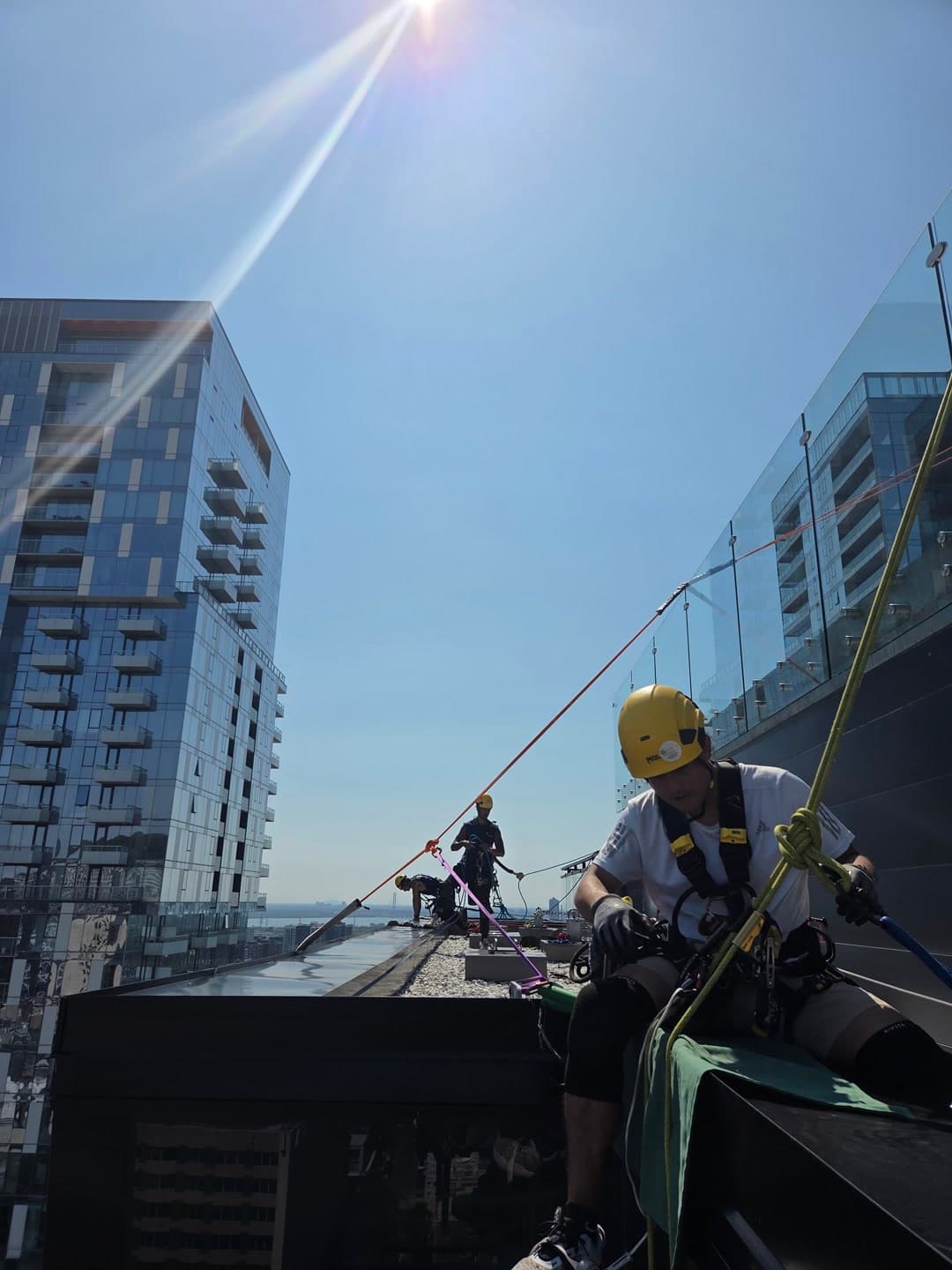 Rope access technicians working on a building facade